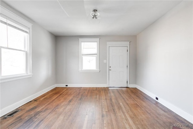 empty room featuring hardwood / wood-style floors and a healthy amount of sunlight