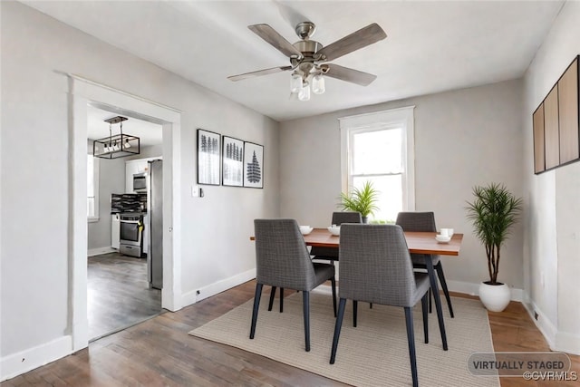 dining area featuring ceiling fan and dark wood-type flooring