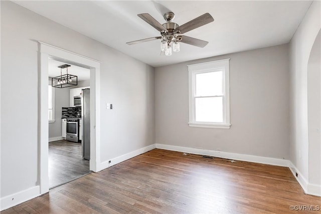 spare room featuring ceiling fan and hardwood / wood-style floors