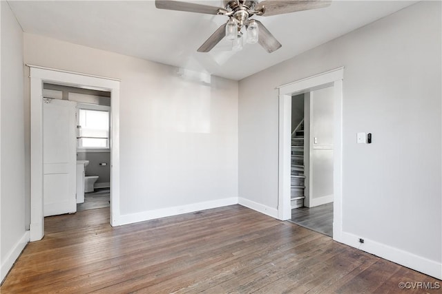 unfurnished room with ceiling fan and dark wood-type flooring