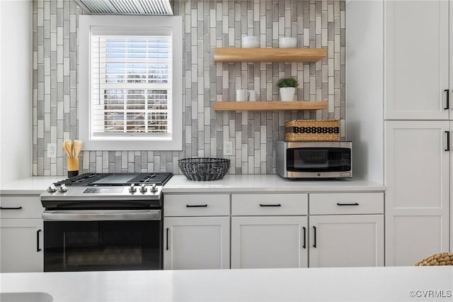 kitchen with appliances with stainless steel finishes, backsplash, and white cabinetry