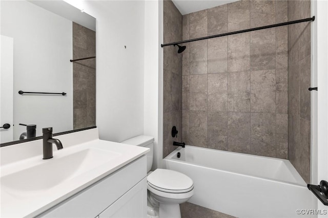 full bathroom featuring toilet, vanity, and tiled shower / bath