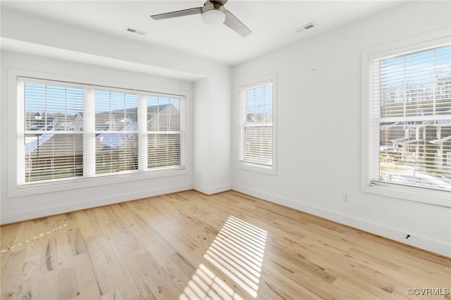 spare room featuring light hardwood / wood-style floors and ceiling fan