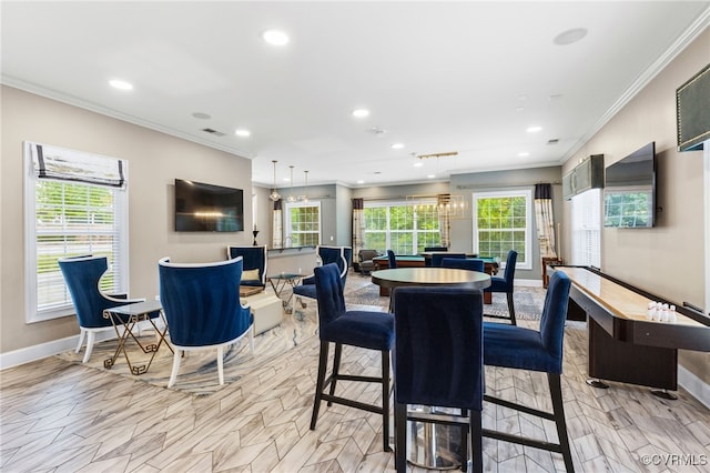 dining space with ornamental molding and a wealth of natural light