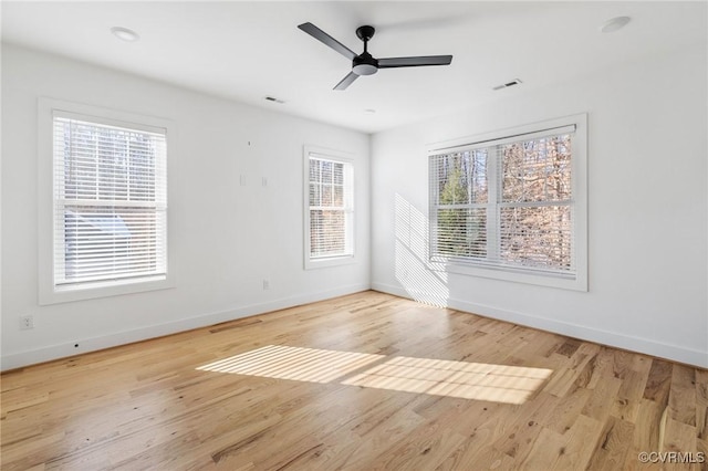 spare room with ceiling fan, light hardwood / wood-style flooring, and plenty of natural light