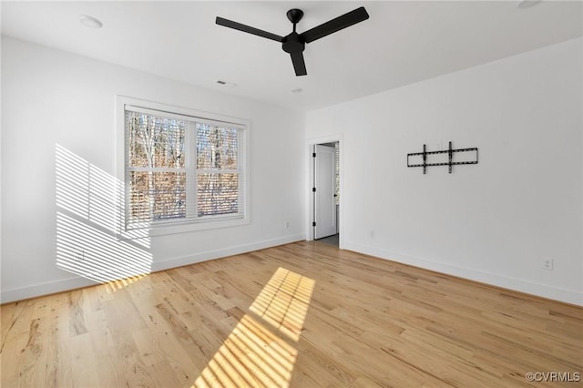 spare room featuring light wood-type flooring and ceiling fan