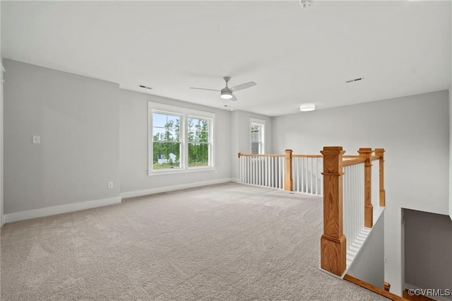 unfurnished room with carpet flooring and ceiling fan