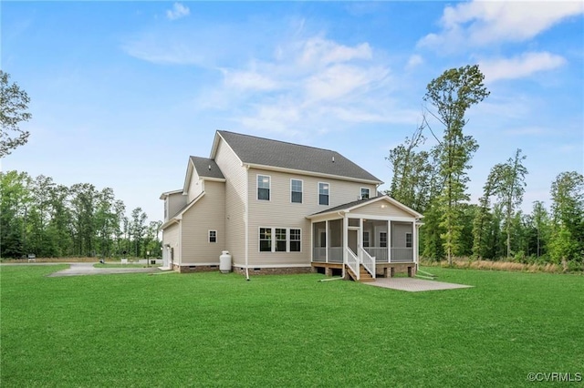 back of house with a sunroom, a patio area, and a lawn