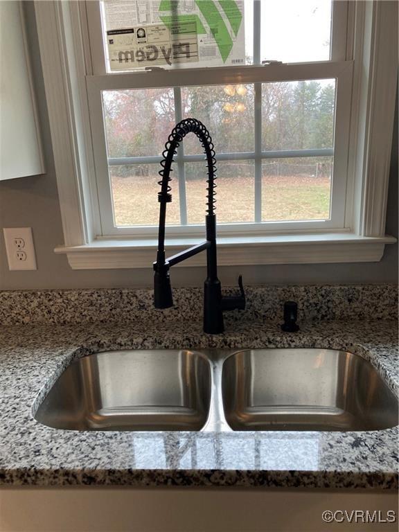 details with stone countertops and sink