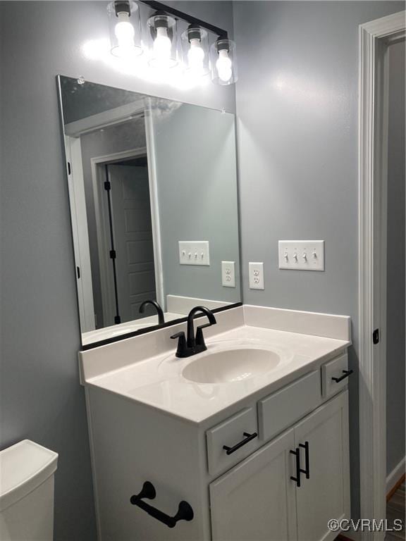 bathroom featuring vanity and toilet