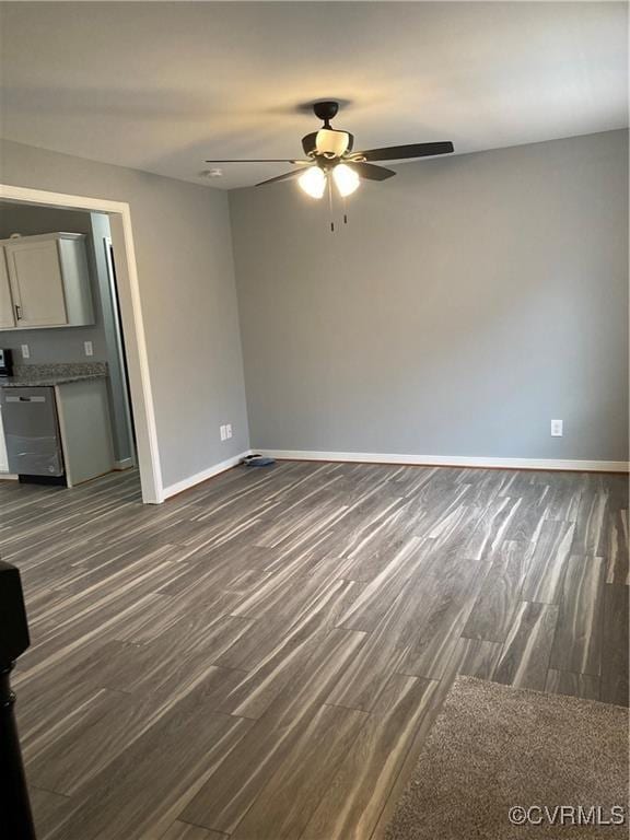 unfurnished living room with ceiling fan and dark hardwood / wood-style flooring