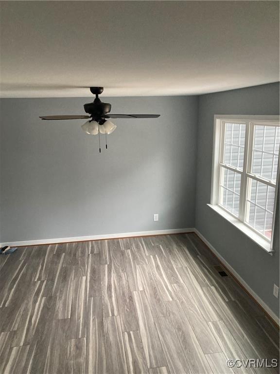 empty room featuring ceiling fan and hardwood / wood-style flooring