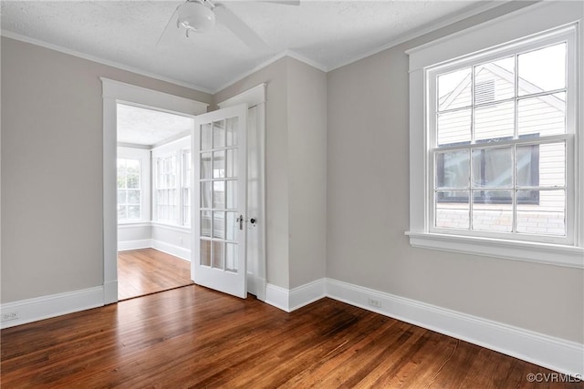 empty room featuring a textured ceiling, ceiling fan, ornamental molding, and wood-type flooring