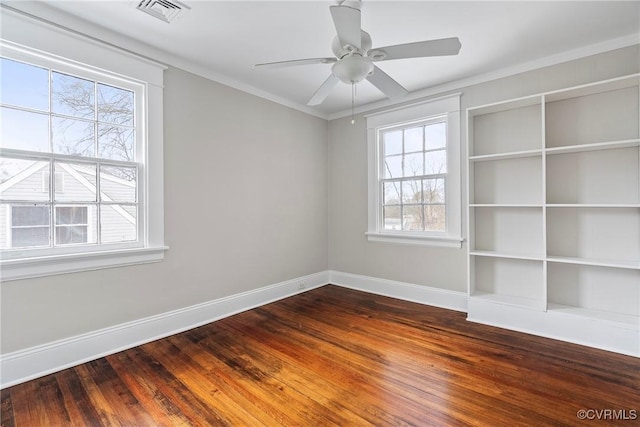 empty room with ceiling fan, a healthy amount of sunlight, and hardwood / wood-style flooring