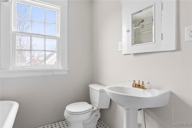 bathroom featuring toilet and plenty of natural light