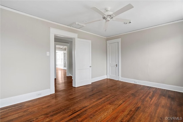 spare room featuring ceiling fan, dark wood-type flooring, and crown molding