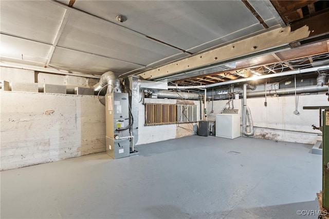 basement with heating unit and washer / dryer