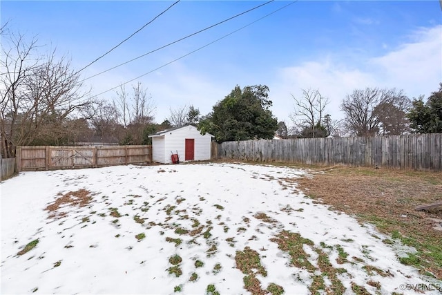 snowy yard with a shed