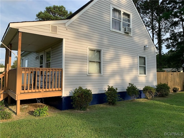 view of side of property with a lawn