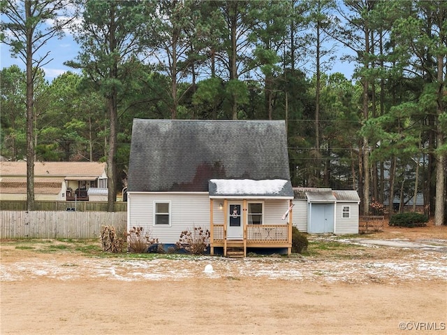 view of front of home with a storage unit and a wooden deck