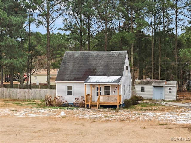 view of front of home with a deck and a shed