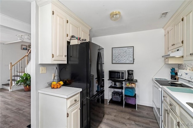 kitchen featuring dark wood-type flooring, white electric range oven, and black fridge