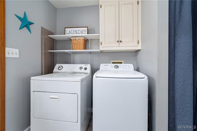 laundry area featuring cabinets and washer and clothes dryer