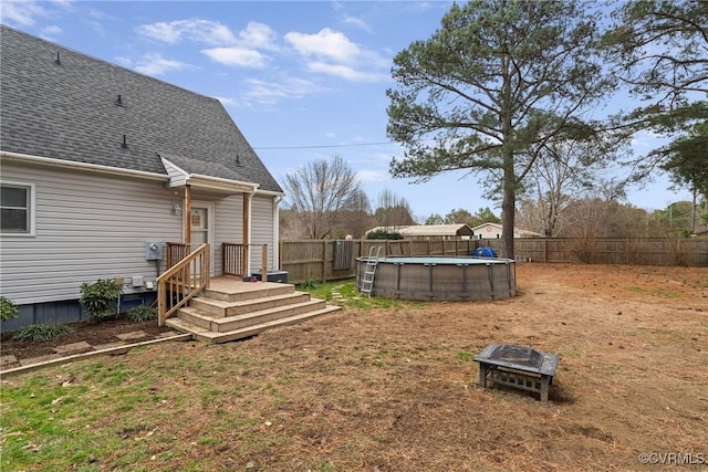 view of yard featuring a fire pit and a fenced in pool