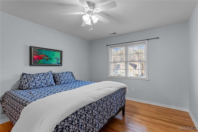 bedroom with hardwood / wood-style floors and ceiling fan