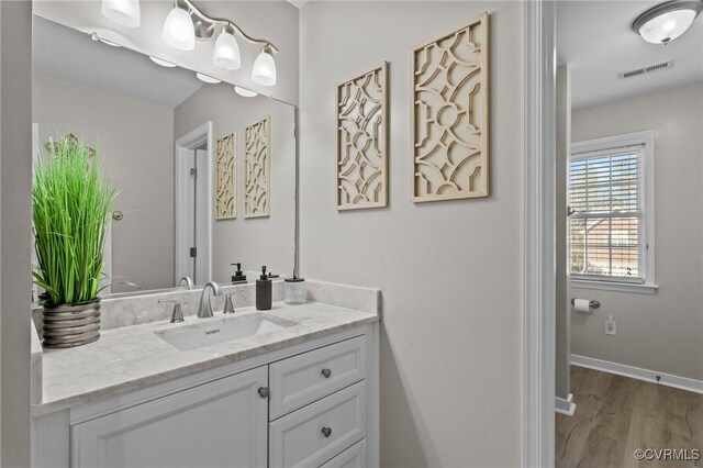 bathroom with vanity and hardwood / wood-style flooring