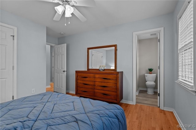 bedroom with ceiling fan, light hardwood / wood-style flooring, and ensuite bath