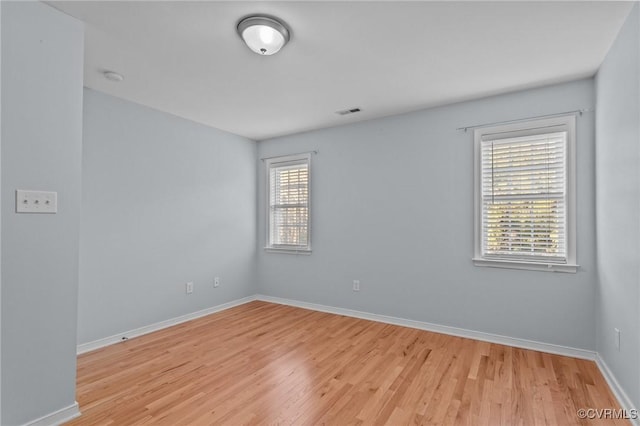 unfurnished room featuring light hardwood / wood-style flooring and a wealth of natural light