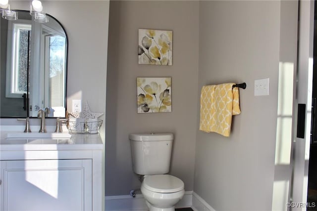 bathroom featuring toilet and vanity