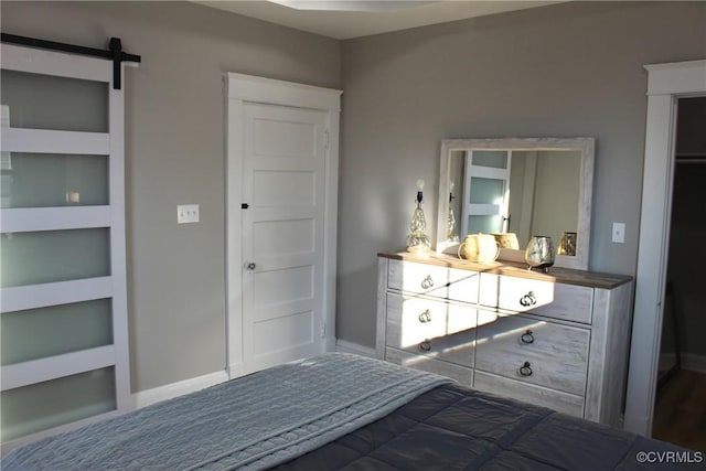 unfurnished bedroom with a barn door and a closet