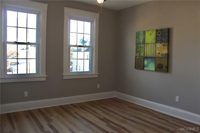 spare room with hardwood / wood-style floors