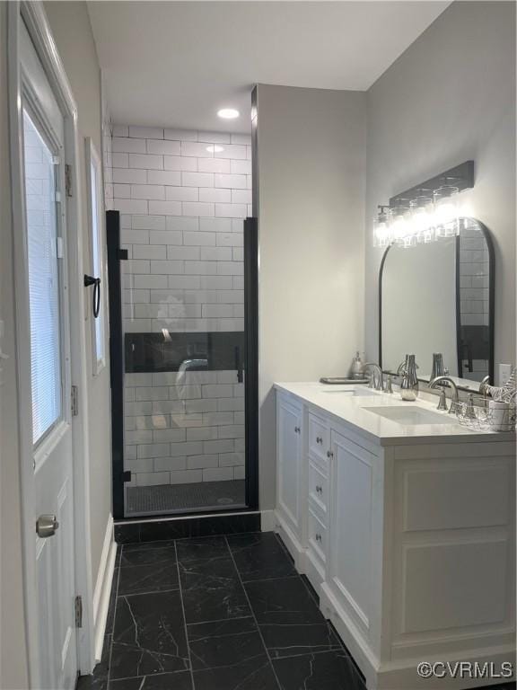 bathroom featuring an enclosed shower and vanity