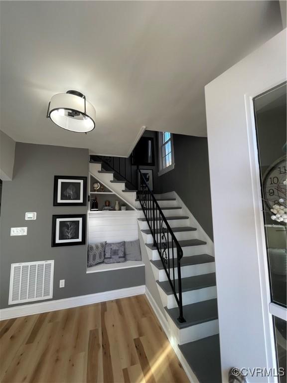 staircase with wood-type flooring