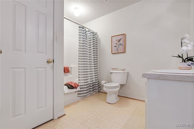 bathroom with vanity, a textured ceiling, toilet, and walk in shower