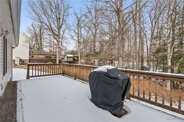 snow covered deck featuring a grill