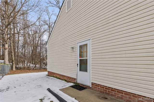 view of snow covered property entrance