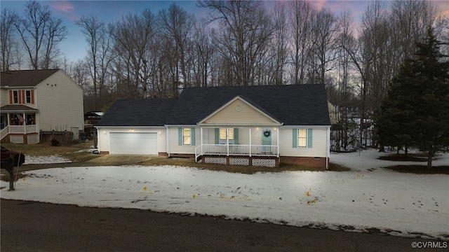 view of front of home with covered porch and a garage