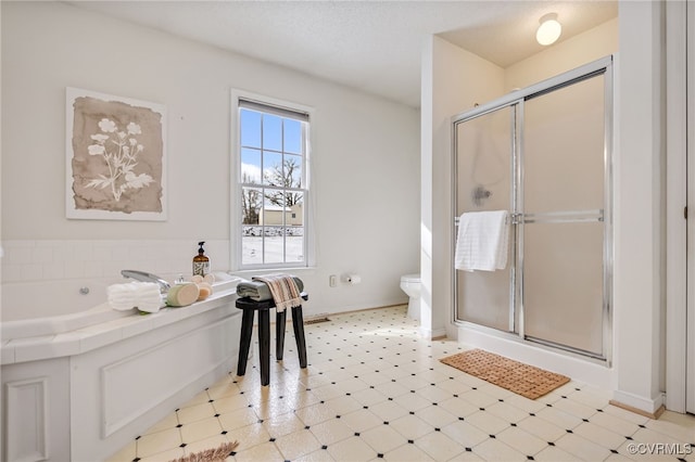 bathroom with separate shower and tub and toilet