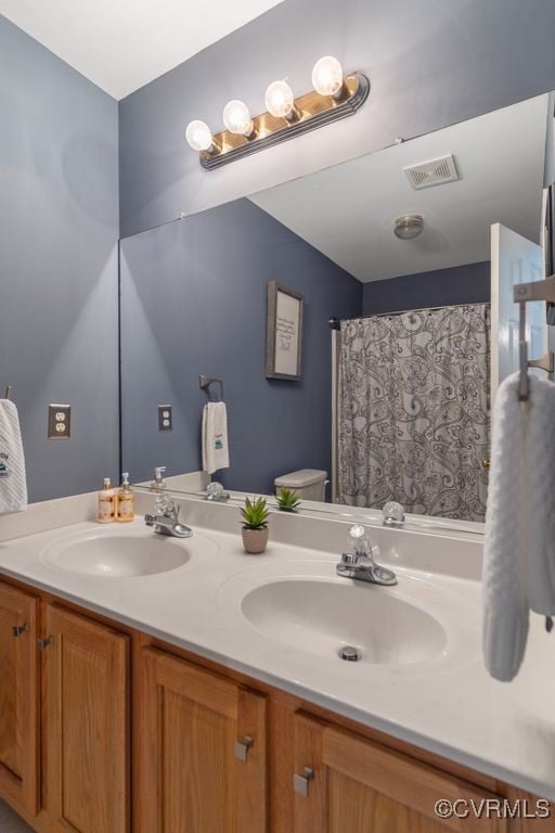 bathroom with toilet and vanity