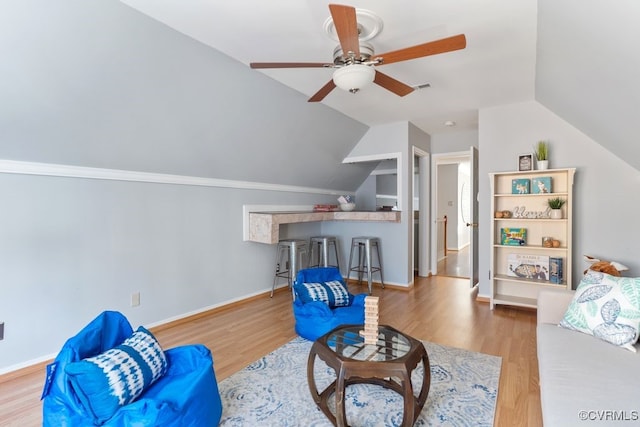 living room featuring lofted ceiling, ceiling fan, and hardwood / wood-style flooring