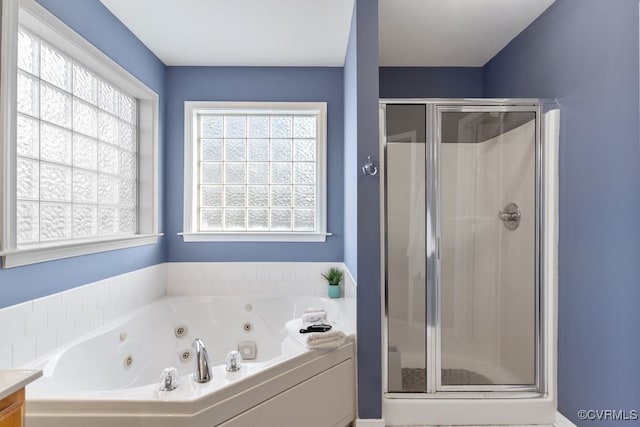 bathroom with vanity and separate shower and tub