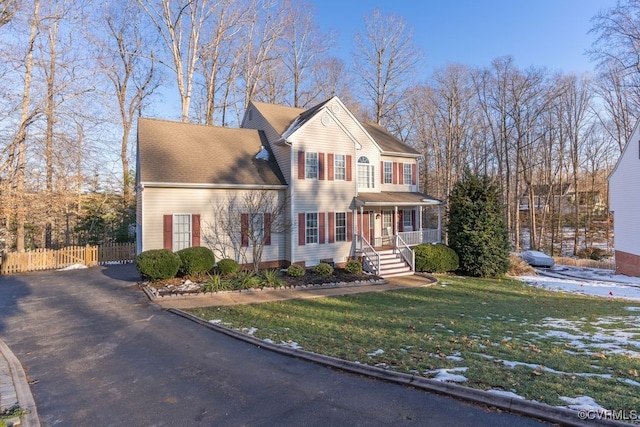 view of front of home featuring a front yard and covered porch