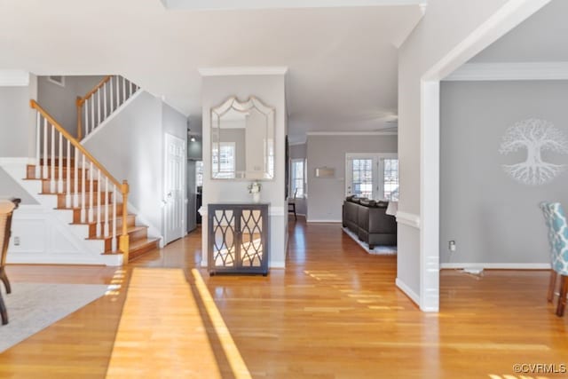 entryway featuring hardwood / wood-style flooring and crown molding