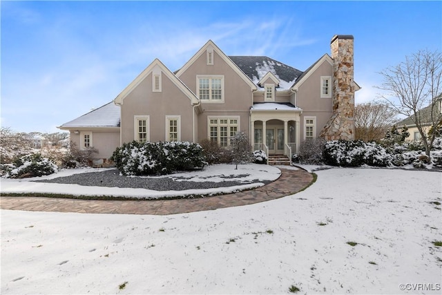 snow covered house featuring french doors