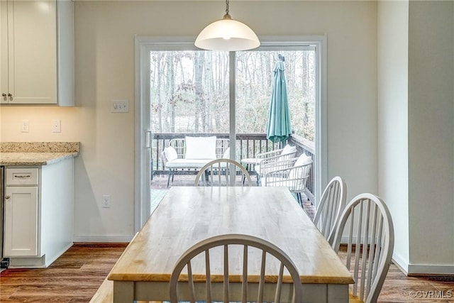 dining space with hardwood / wood-style flooring