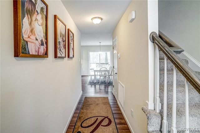 hallway with dark wood-type flooring